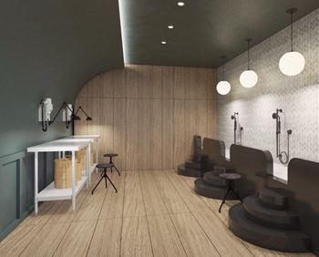a small hair salon with wood flooring and a white table with stools